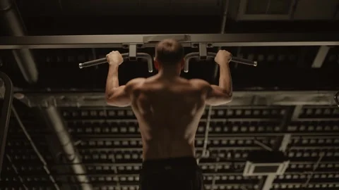 Back view muscular man doing wide grip pull ups on horizontal bar. Stock Footage 271407677