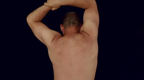 Back view of naked man stretching body 库存影片 62255122