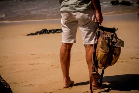 Back view of not recognizable people man traveler with backpack - barefoot at Stock Photos