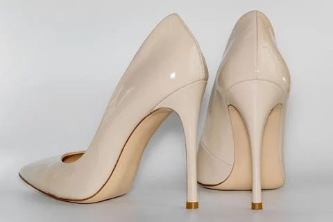 Back view of the nude beige colored high heeled women's shoes. Stock Photos