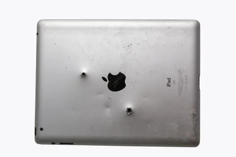 Back view of old silver Ipad with bullet holes. Russia, 22.03.2020 Stock Photos