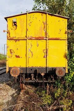 Back view of an old yellow train, abandoned and rusty Stock Photos