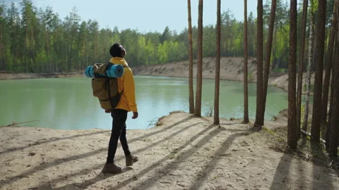 Back view of one black man looking on mountain and lake. Slow motion Stock Footage 154786749