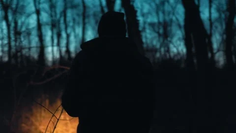 Back View One Man Walking Through Dark Forest With Flashlight lifestyle Stock Footage 334002291