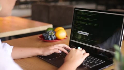 Back view over the shoulder shot of developer programmer female with laptop Stock Footage 161149152