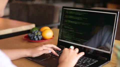 Back view over the shoulder shot of developer programmer female with laptop Stock Footage 161259591