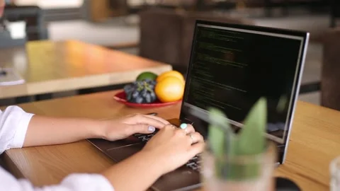 Back view over the shoulder shot of developer programmer female with laptop Stock Footage 161475790