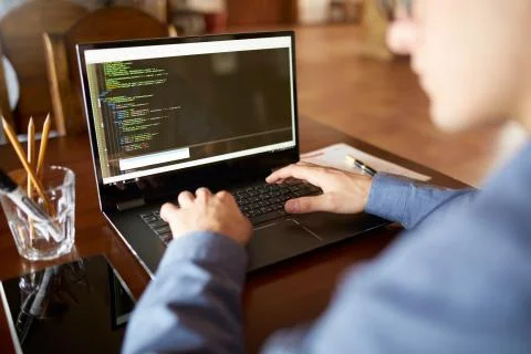 Back view over the shoulder shot of developer programmer with laptop. Program Stock Photos
