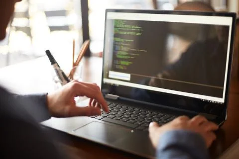 Back view over the shoulder shot of developer programmer with laptop. Program Stock Photos