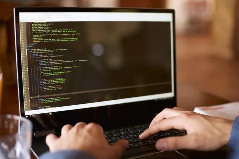 Back view over the shoulder shot of developer programmer with laptop. Program Stock Photos