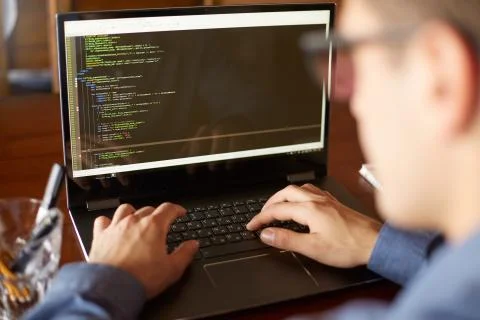 Back view over the shoulder shot of developer programmer with laptop. Program Stock Photos
