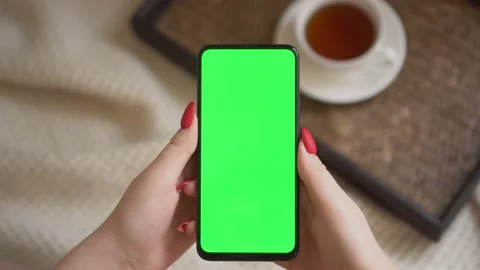 Back view over shoulder of young girl using smartphone with green screen sitting Stock Footage 142079256