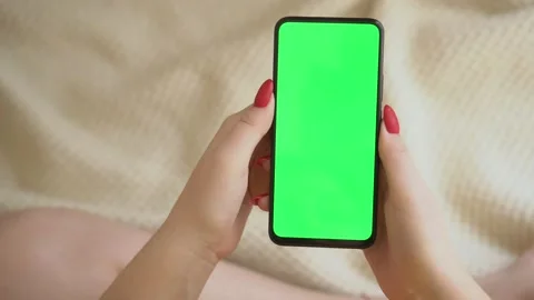 Back view over shoulder of young girl using smartphone with green screen sitting Stock Footage 142491353