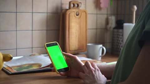 Back view over shoulder of young girl using smartphone with green screen. Stock Footage 152174019