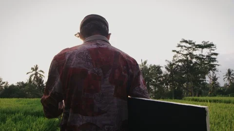 Back view of painter going to work in field Stock Footage 98962991