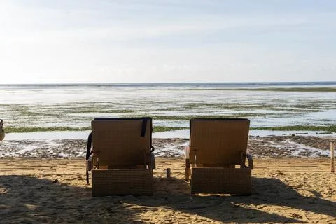Back view of a pair of lounge chairs on the beach Stock Photos