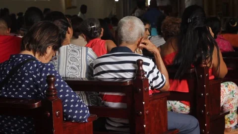 Back view of people sitting inside a church in Latin America Stock Footage 86520167