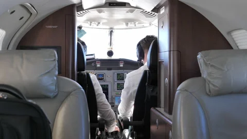 Back View Of Pilot And Co-Pilot In The Cockpit Of A Private Jet Plane. Stock Footage 221985662
