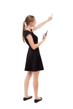 Back view of pointing young beautiful  woman and using a mobile phone Stock Photos