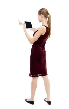 Back view of pointing young beautiful girl with tablet computer back view ... Stock Photos