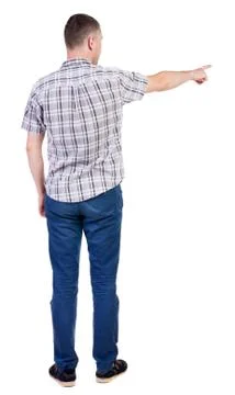 Back view of  pointing young men in  shirt and jeans. Young guy  gesture. Rear Stock Photos