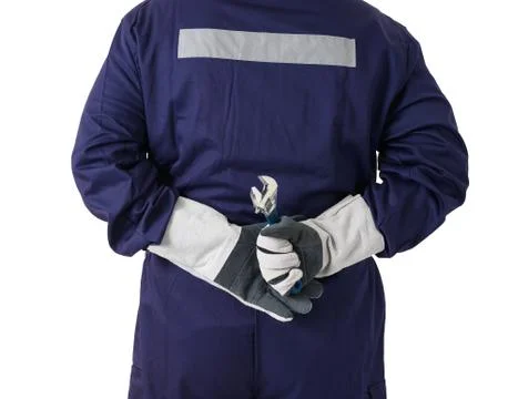 Back view portrait of a worker in Mechanic Jumpsuit is holding a wrench isola Stock Photos