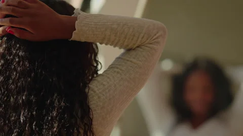 Back view. Pretty dark-skinned young woman in white top dances by mirror Stock Footage 259149961