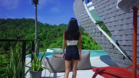 Back View Pretty Girl Walking Towards An Infinity Pool In Luxurious Villa Stock Footage 164455892