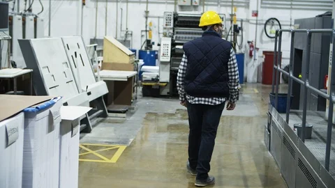 Back view of printing worker walking at factory Video stock 127345831