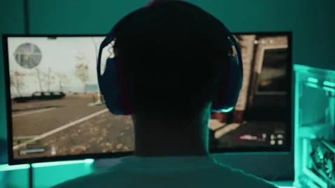Back view of professional cyber player wearing gaming headset competing in first Stock Footage 317161732