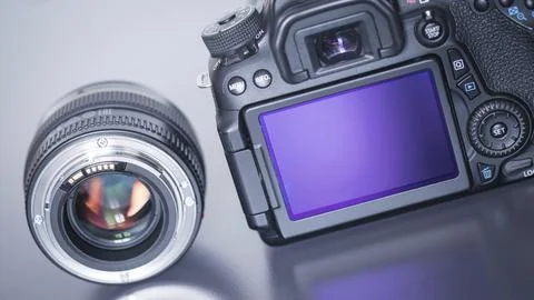 Back view of a professional reflex camera with flip lsd screen and a photo lens Stock Photos