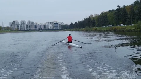 Back view of a professional rower training on rowing canal, 4k footage Stock Footage 70803668