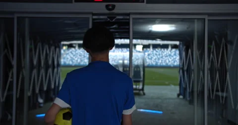 Back view of professional soccer player going to empty stadium with ball, man Stock Footage 139218206
