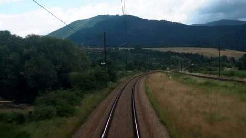 Back view of railroad train pass with beautiful green nature and mountains view Stock Footage 114383015