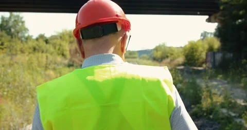 Back view of railroader in uniform walking on the railway 動画素材 135569572