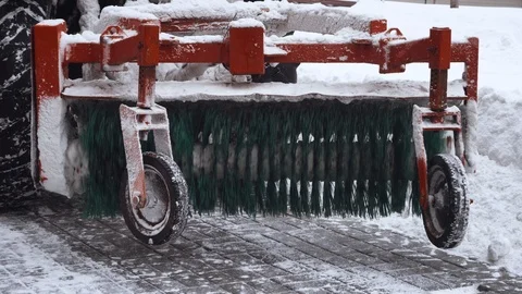 Back view of the red snow-removing machine clears the runway from the snow.  Stock Footage 100303971