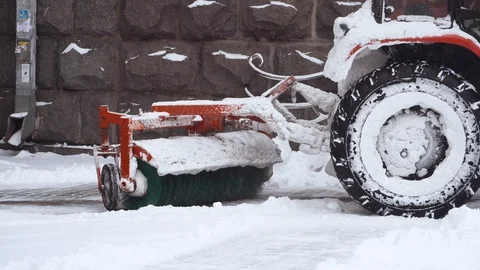 Back view of the red snow-removing machine clears the runway from the snow.  Stock Footage 100304004
