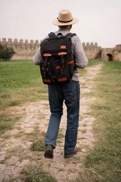 Back view of retired tourist with backpack traveling in retirement Stock Photos