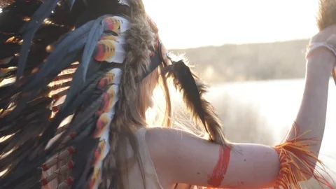 Back view of ritual dance on the sunsett of beautiful girl in native american in Stock Footage 110693182