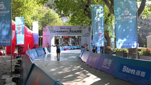 Back View of Runner Raising Poles Toward Finish Arch, Lushan 스톡 동영상 346719286