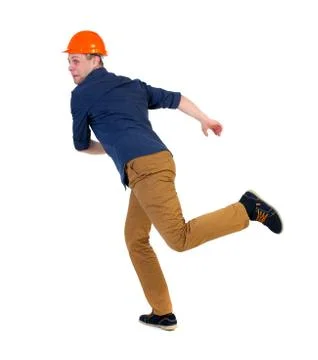 Back view of running engineer in helmet Stock Photos