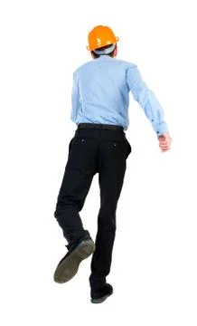 Back view of running engineer in helmet Foto stock