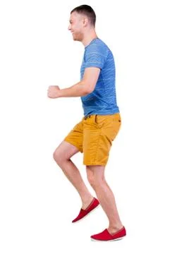 Back view of running man in t-shirt and shorts Stock-Fotos