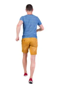 Back view of running man in t-shirt and shorts Stock Photos