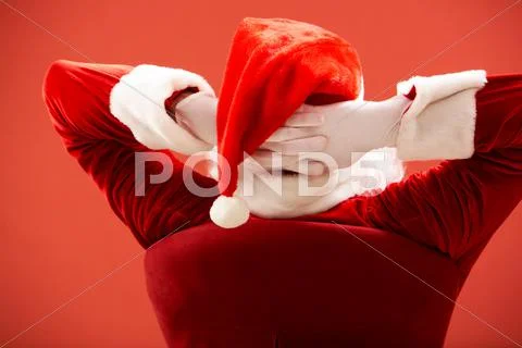 Back view of santa claus keeping his hands behind head Stock Photos
