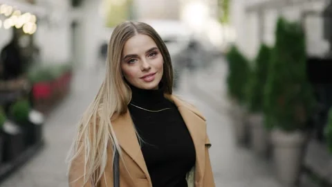 Back view of seductive hot blonde woman walking on city street in slow motion Stock Footage 144572482