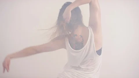 Back View of Seductive Woman dancing on Knees in Studio with Fog Video stock 120572140