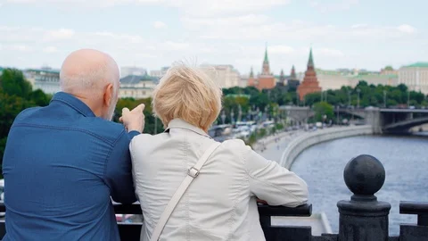 Back view of senior couple stand on observation deck look around city Video stock 95807928