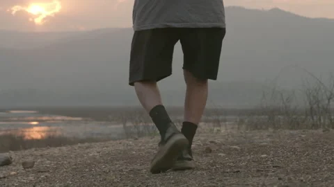 Back view of senior man legs jogging by the lake at sunset. healthy lifestyle Stock Footage 170530626