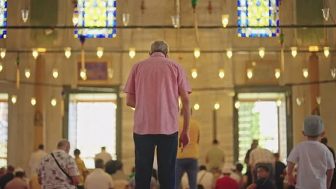 Back View of Senior Muslim Man Praying inside Mosque Behind Other Worshipers as Stock Footage 287990166